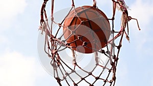 Shooting basketball ball into the basket in layup