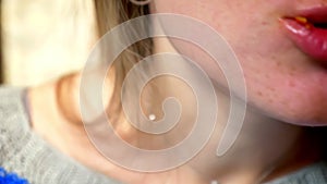 Shooting of caucasian girl lips close-up biting slice of pizza with meat, cheese, delicious ingredients, fresh order