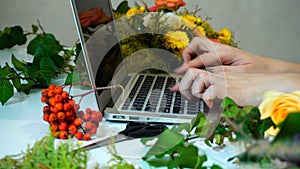 Shooting close-up of computer on which girl`s hand prints floris