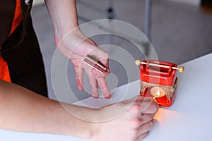 Shooting close-up of hand of male masseur who creates aromatic a