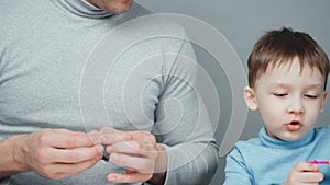 Shooting of dad and little boy making toys from plasticine