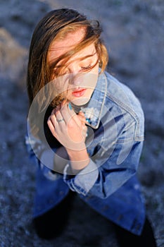 Shooting female portrait in profile on shore of Black Sea on war