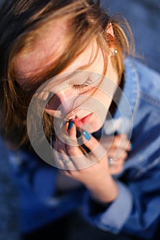 Shooting female portrait in profile on shore of Black Sea on war