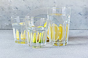 Shooting through glass objects with water. Orange lemon reflecting through a glass cup with water