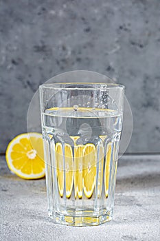 Shooting through glass objects with water. Orange lemon reflecting through a glass cup with water