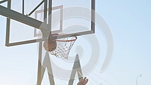 Shooting goal during basketball game on urban ground