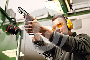 Shooting a gun at a shooting range