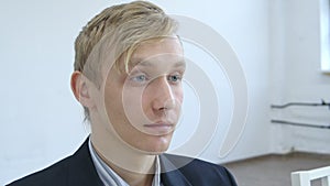 Shooting of impudent blond man sitting in waiting