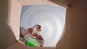 Shooting of man throwing unsorted trash, bottom view
