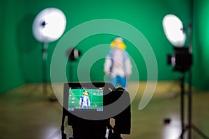 Shooting the movie on a green screen. The chroma key. Studio videography. Actress in theatrical costume