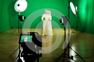 Shooting the movie on a green screen. The chroma key. Studio videography. Actress in theatrical costume