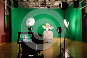 Shooting the movie on a green screen. The chroma key. Studio videography. Actress in theatrical costume