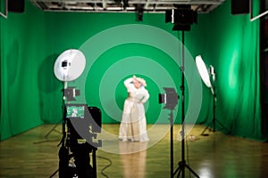 Shooting the movie on a green screen. The chroma key. Studio videography. Actress in theatrical costume