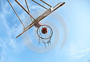 Shooting orange basketball ball into the basket