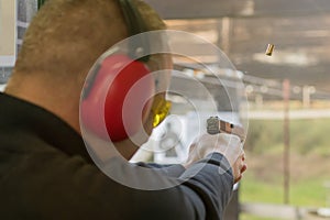 Shooting with a pistol. Man Firing pistol in shooting range.