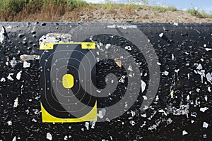 Shooting range target with bullet holes at a gun range