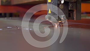Shooting is a slow movement, close -up. CNS laser cutting machine, working with leaf metal with a spark at the factory