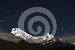Shooting star over the snow mountain