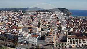 Shooting from top view a small european town near the sea and mountains.