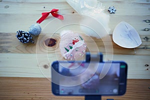 Shooting videoblog of Christmas DIY. Backstage do it yourself tutorial. Cell phone on magic arm making video of handmade