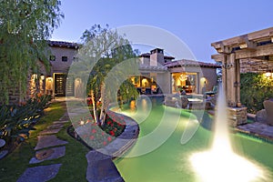 Shooting water outside House Exterior with swimming pool and hot tub photo