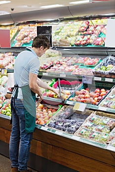 Shop assistant arranging shelves