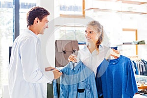 Shop assistant helping to choose clothes