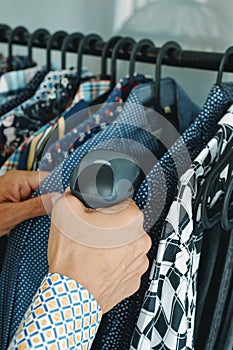 shop assistant uses a barcode scanner in a clothes shop