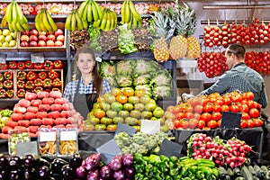 Shop assistants working in fruit and vegetable shop photo