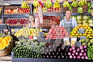 Shop assistants working in fruit and vegetable shop photo