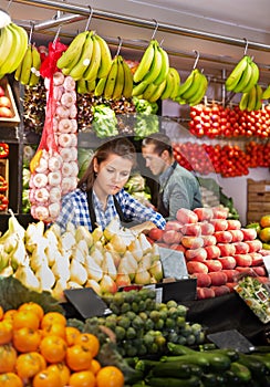 Shop assistants working in fruit and vegetable shop photo