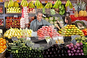 Shop assistants working in fruit and vegetable shop photo