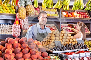 Shop assistants working in fruit and vegetable shop photo