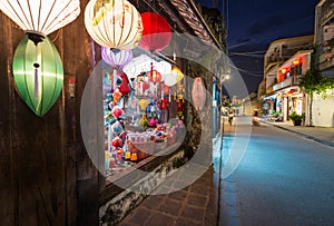 Shop with big window and colorful lanterns.