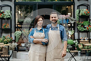 Shop and flower studio owners, waiters in eco cafe and greeting customers outdoor