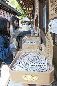Shop inside Shinto shrine and Buddhist temple in Japan selling Omikuji or strips of paper with fortunes for visitors
