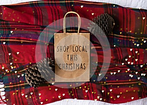 Shop Local This Christmas text on a plain brown paper bag flat la
