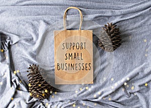 Support Small Businesses text on a plain brown paper bag flat lay