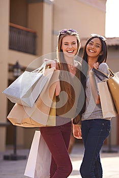 Shop shop shop. Two attractive young woman with their shopping bags after a day of retail therapy.