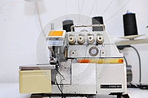 Shop for tailoring. A woman creates clothes on a sewing machine. Fashion industry for people. Stylish fashionista woman