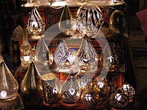 Shop vendor selling copper lamps in khan el khalili souq market in egypt cairo photo