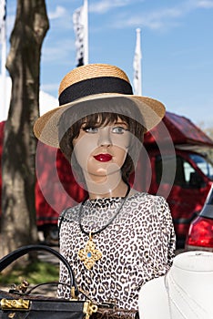 Shop window doll head with hat on a flea market