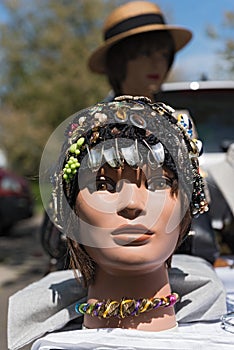 Shop window doll head with head decoration at a flea market