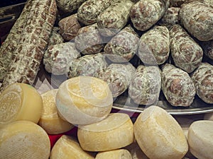 Shop window of a food store with traditional Italian foods, salami and cheese
