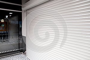 Shop window with roller shutters for protection from vandals