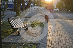 ShopA bench bathed in the evening sunset sun in the park
