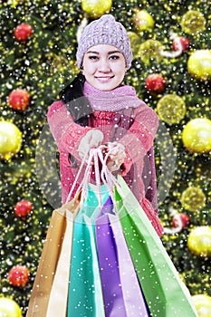 Shopaholic giving shopping bags