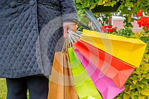 Shopaholic woman holding colorful shopping bags