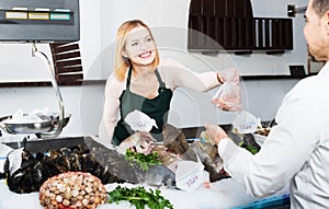 Shopgirl in fresh fish store