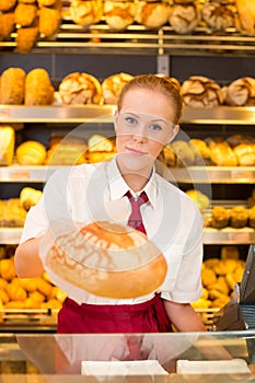 Shopkeeper in Bakery giving bread to customer